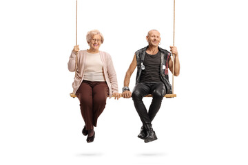 Elderly woman and a punk sitting on a swing together