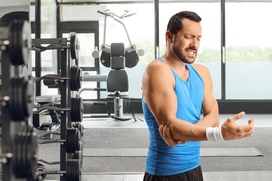 Male atlete at a gym feeling elbow pain