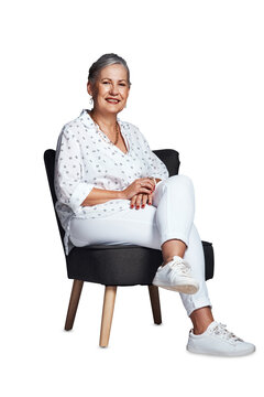 Portrait, senior woman and sitting in chair for rest and relaxation on holidays or at weekend. Calm retired female person with smile, casual clothes and isolated on transparent png background