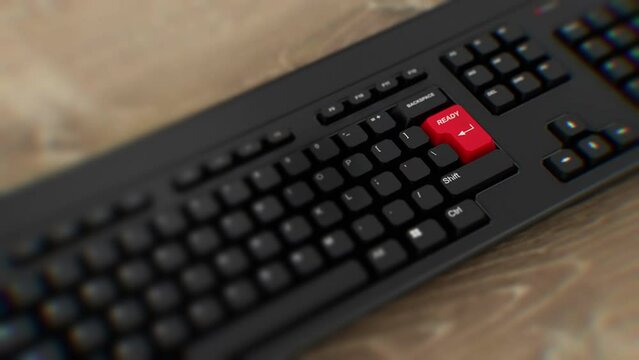 Ready button on keyboard, wide shot. A finger presses Enter. Click ready. Realistic keyboard button. Red button ready. Get ready. Prepared. Set for action. Office keyboard with unique word to 
