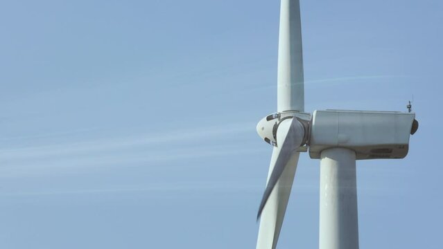 Wind turbine spinning with virtual digital effect of wind flowing. Wind power turbines generating clean renewable energy for sustainable development in a green ecologic way.
