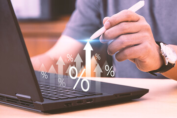 Interest rates and dividend concepts Businessman touching arrow with percentage icon Calculating...
