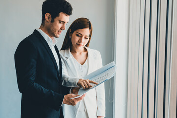 Businessman executive is in meeting discussion with businesswoman or client in modern workplace...