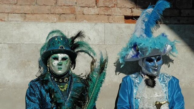 Venice, Italy - February 13, 2024 - carnival masks are photographed with tourists in San Marco square