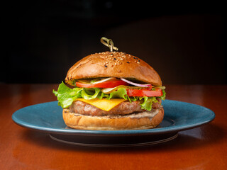Burger, sandwich, hamburger with chicken cutlet, onion, cucumber, cheese and tomato.