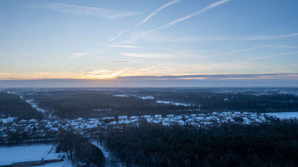 An aerial perspective captures the serene beauty of a winter morning as the first light of dawn...