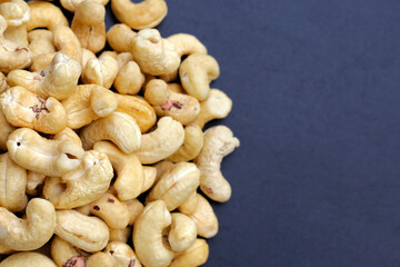 Cashew nuts on dark background.