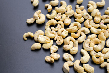 Cashew nuts on dark background.