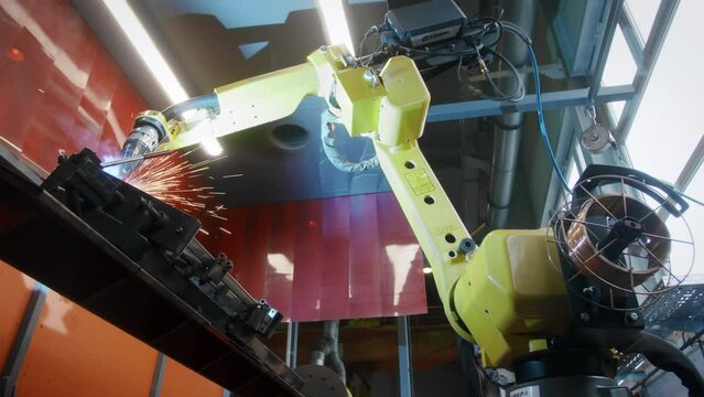 Metal iron laser argon welding robot in factory. Industrial robotics. Automation of work. Manufacture of industrial equipment.