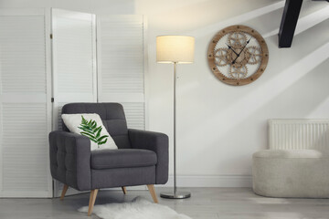 Soft pillow with printed tropical leaf on armchair indoors