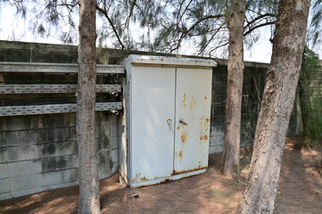 BANGKOK, THAILAND - February 15, 2024: Old rusty iron cabinet abandoned on the side of the road with natural background at Thailand.