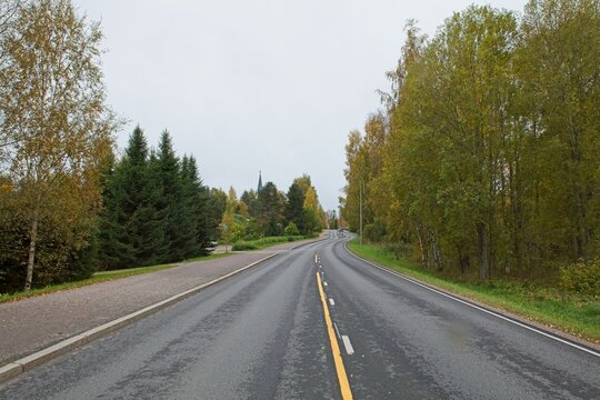 Kirkkotie (295) road in cloudy autumn weather, Kärkölä Kirkonkylä, Finland.