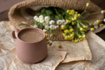 Cup of cappuccino with milk or cacao and wildflowers
