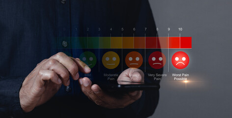 Man using smartphone to complete pain measurement assessment on colorful icons, virtual reality screen Emotions range from happy blue to crying red. medical technology and future concepts