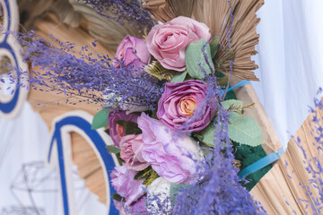 Close-up view of a lavish wedding reception table setting with beautiful purple flowers and vintage...