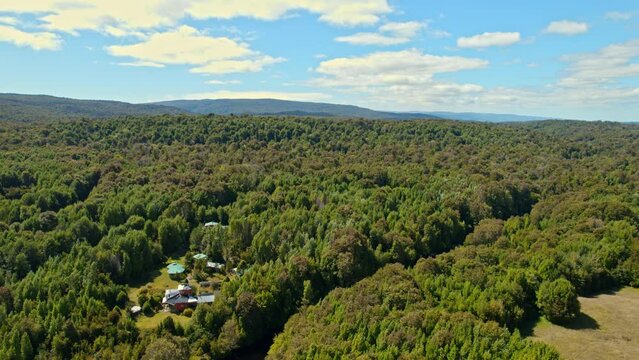 High above  the logde view of tepuhueico park with its virgin forest on a sunny day, Chiloe, Chile