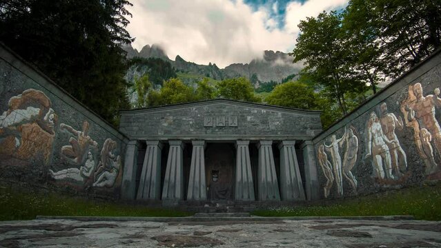 Time lapse in front of the peace monument Paxmal with the imposing Churfirsten mountain range in the background. the clouds dance across the landscape