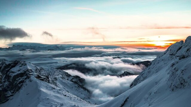 Time lapse in winter at sunset on the mountain peak Pilatus in Switzerland. the clouds dance between the mountains