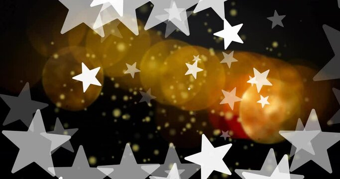 Animation of white stars over orange and yellow light spots on black background