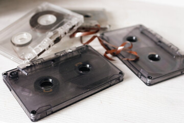 Old audio tape on white background. Retro audio format. Cassette tapes. 90's nostalgia concept. Old fashioned lifestyle. Archival objects. Analogue record equipment. Vintage music storage.