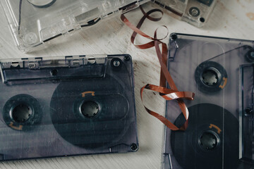 Old audio tape on white background. Retro audio format. Cassette tapes. 90's nostalgia concept. Old fashioned lifestyle. Archival objects. Analogue record equipment. Vintage music storage. Aged audio 