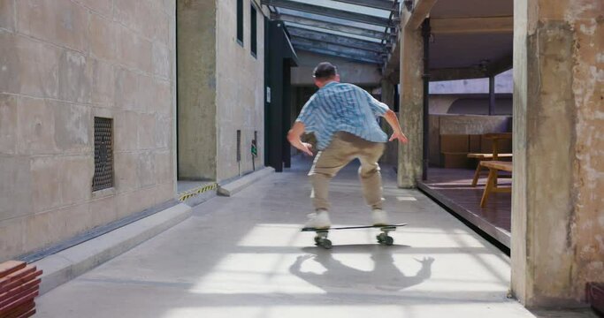 Young man enjoys riding a skateboard.
