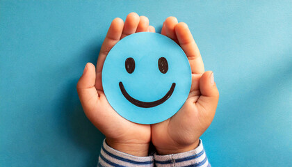 Closeup of a hands of a child (hands cupped,) holding a smiley face made of blue paper on a blue background with copy space. Generative Ai.