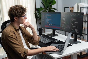 Working IT developer with stressful overworked in creating online software development coding on pc screen, thinking program for latest version application on website project at modern office. Gusher.