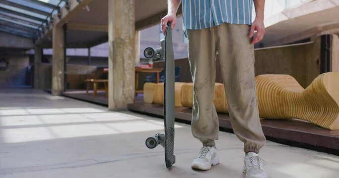 Skateboarder picking up his skate.