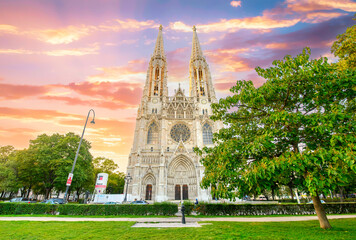 Votivkirche or Votive Church in Vienna, Austria. Famous Neo-Gothic church on Ringstrasse - second-tallest church in Wien. Church consecrated in 1879 on occasion of Imperial Couple's Silver Wedding.	
 - obrazy, fototapety, plakaty