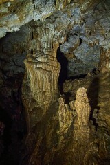 A wild cave inside. Stalactites and stalagmites. Speleology and surveys