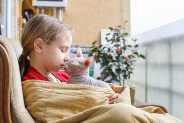 Cute child girl and cat pet on the balcony