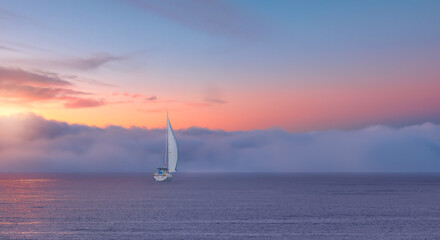 Lonely yacht sailing in the Mediterranean sea at amazing sunset - Sailing luxury yacht with white...