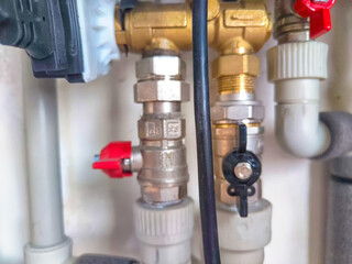 Close-Up of Domestic Water Shut-Off Valves. detailed view of the copper piping and two types of...