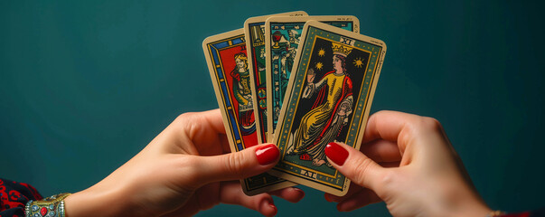 Hands holding 4 beautiful tarot and oracle card on dark green background, inviting users to seek guidance, self-reflection, and spiritual insights. These cards serve as powerful tools for divination. - obrazy, fototapety, plakaty