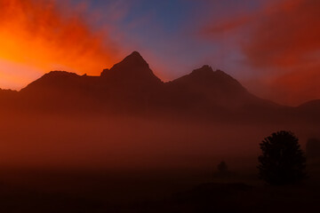 Foggy alpine sunrise view with Mount Sonnenspitze at Lermoos, Reutte, Tyrol, Austria