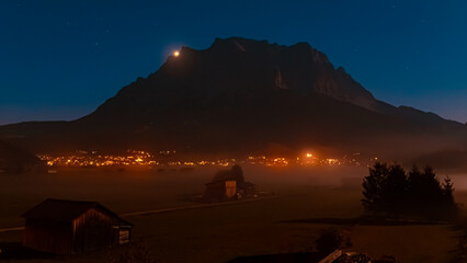 Fototapeta na wymiar Foggy alpine long exposure night view with Mount Zugspitze at Lermoos, Reutte, Tyrol, Austria