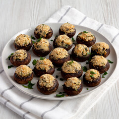 Homemade Garlic Parmesan-Stuffed Mushrooms on a plate, side view.