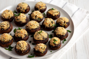 Homemade Garlic Parmesan-Stuffed Mushrooms on a plate, side view.