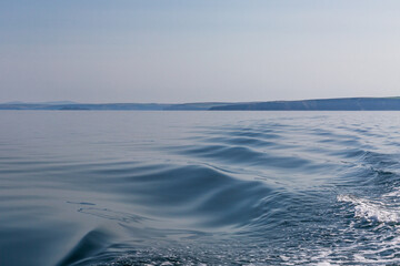 Looking over the ocean from a boat towards the coast