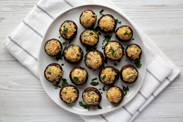 Homemade Garlic Parmesan-Stuffed Mushrooms on a plate, top view. Flat lay, overhead, from above.