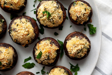 Homemade Garlic Parmesan-Stuffed Mushrooms on a plate, top view. Close-up.