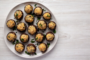 Homemade Garlic Parmesan-Stuffed Mushrooms on a plate, top view. Space for text.