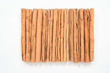Collection of dried organic cinnamon sticks isolated on white background. top view. spices 