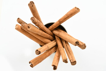 Collection of dried organic cinnamon sticks isolated on white background. top view. Ceylon spices.