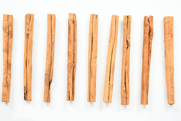 Top view of organic cinnamon sticks isolated on white. Fragrant cinnamon sticks isolated on white background.
