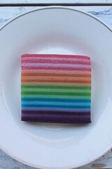 Traditional Indonesian food called lapis warna warni in a white plate on the table