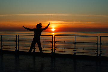 Girl silhouette in magical sunset over the Gulf of Finland, Baltic sea.