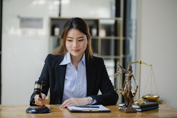 Concepts of Law and Legal services. Lawyer asian woman working at law office.