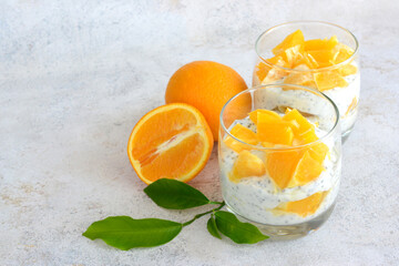 healthy snack with yogurt, chia seeds and chopped orange fruit